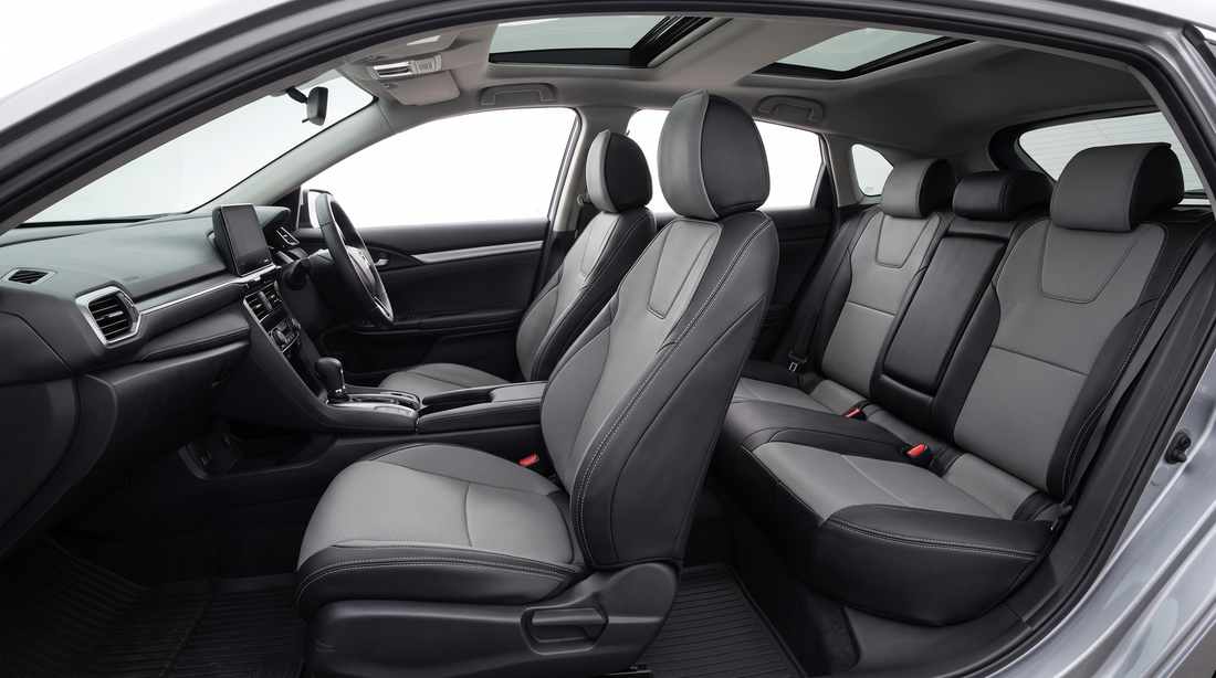 Leather-style seat cushion covers inside a compact hybrid hatchback